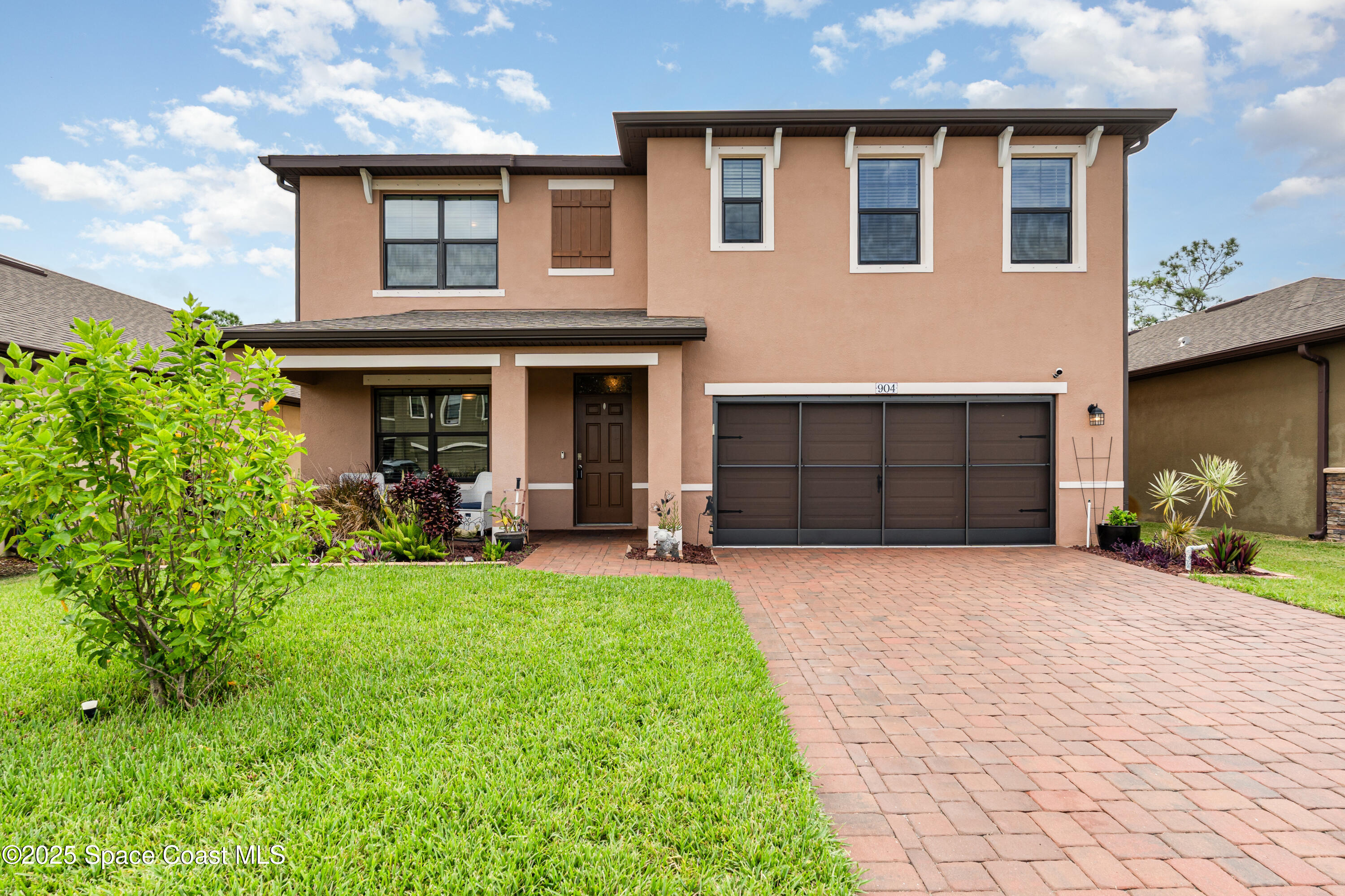 a front view of a house with a yard and garage