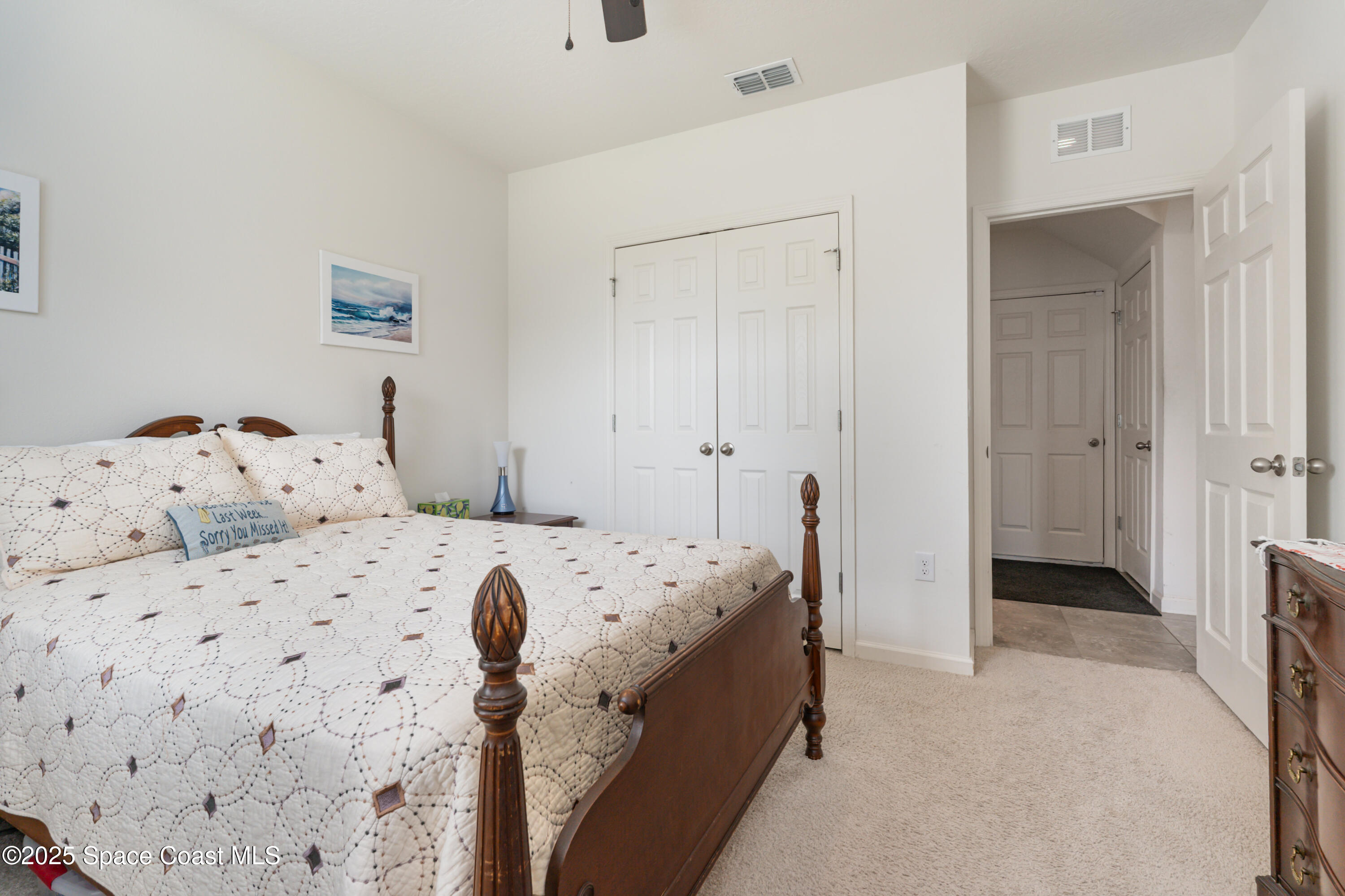 904 Old Country Rd S East Palm Bay, FL 32909 - Photo 13 of 25 a bedroom with a bed and a view of bathroom
