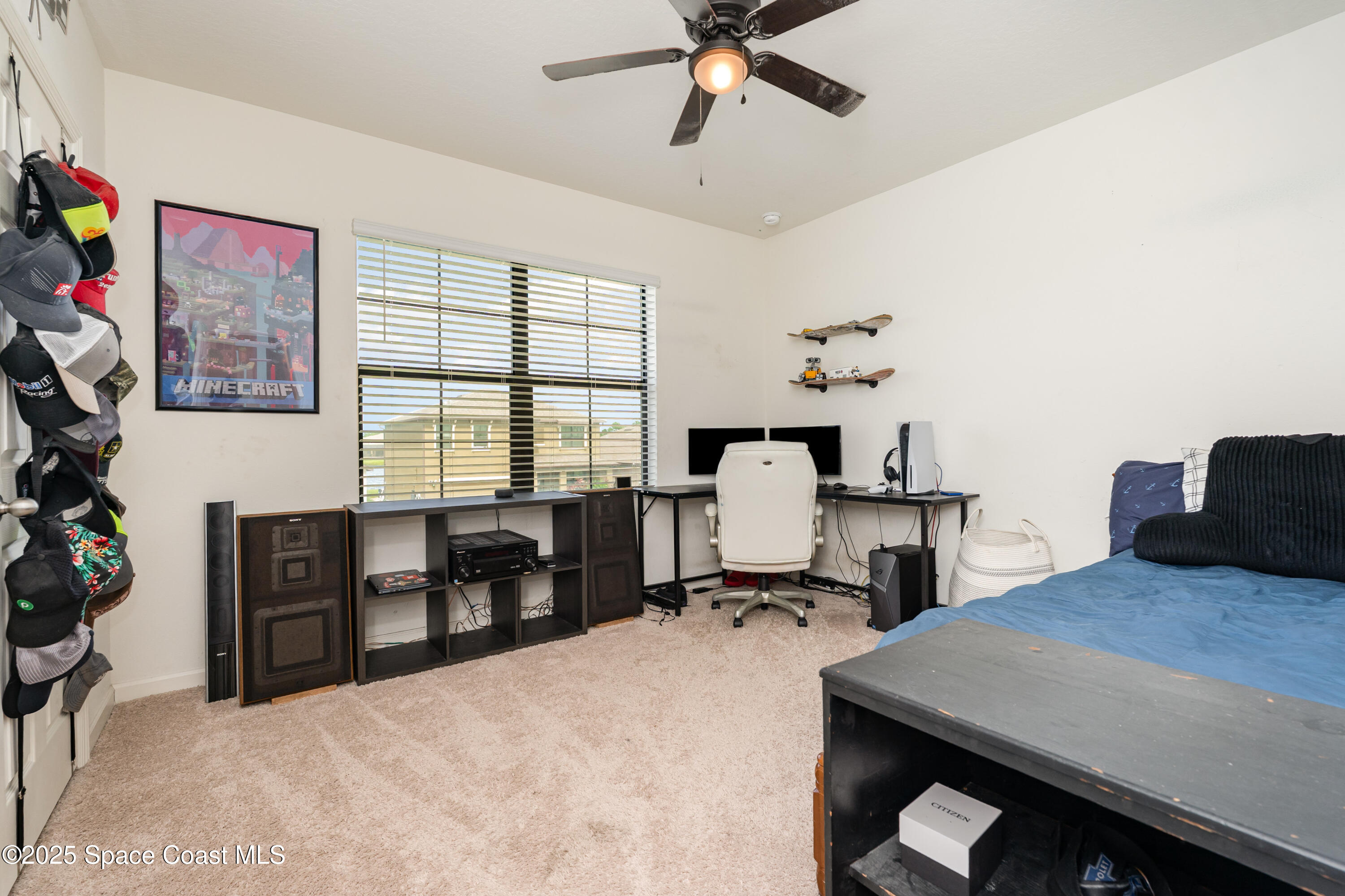 904 Old Country Rd S East Palm Bay, FL 32909 - Photo 16 of 25 a bedroom with a bed and a desk