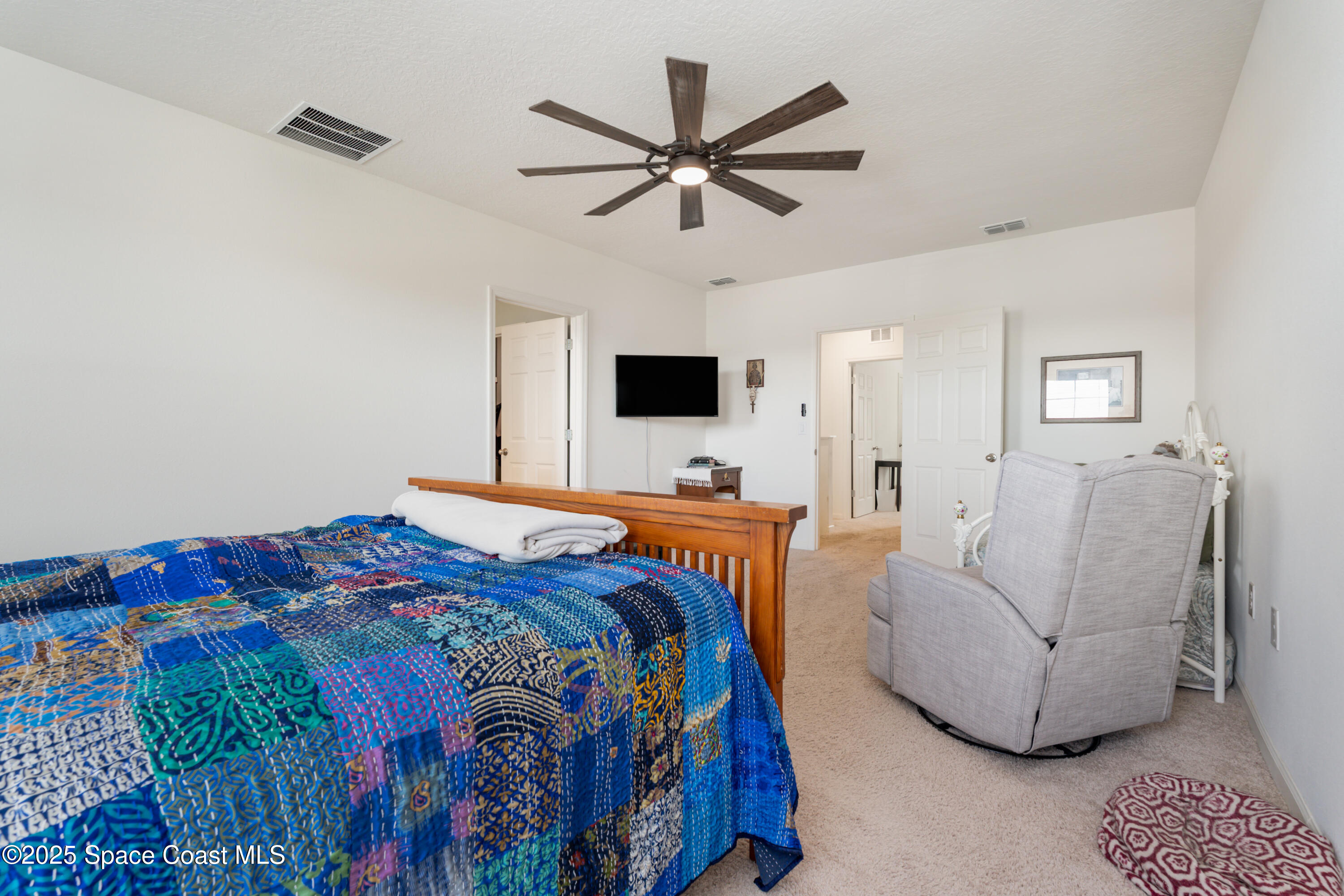 904 Old Country Rd S East Palm Bay, FL 32909 - Photo 19 of 25 a bedroom with a large bed and a window
