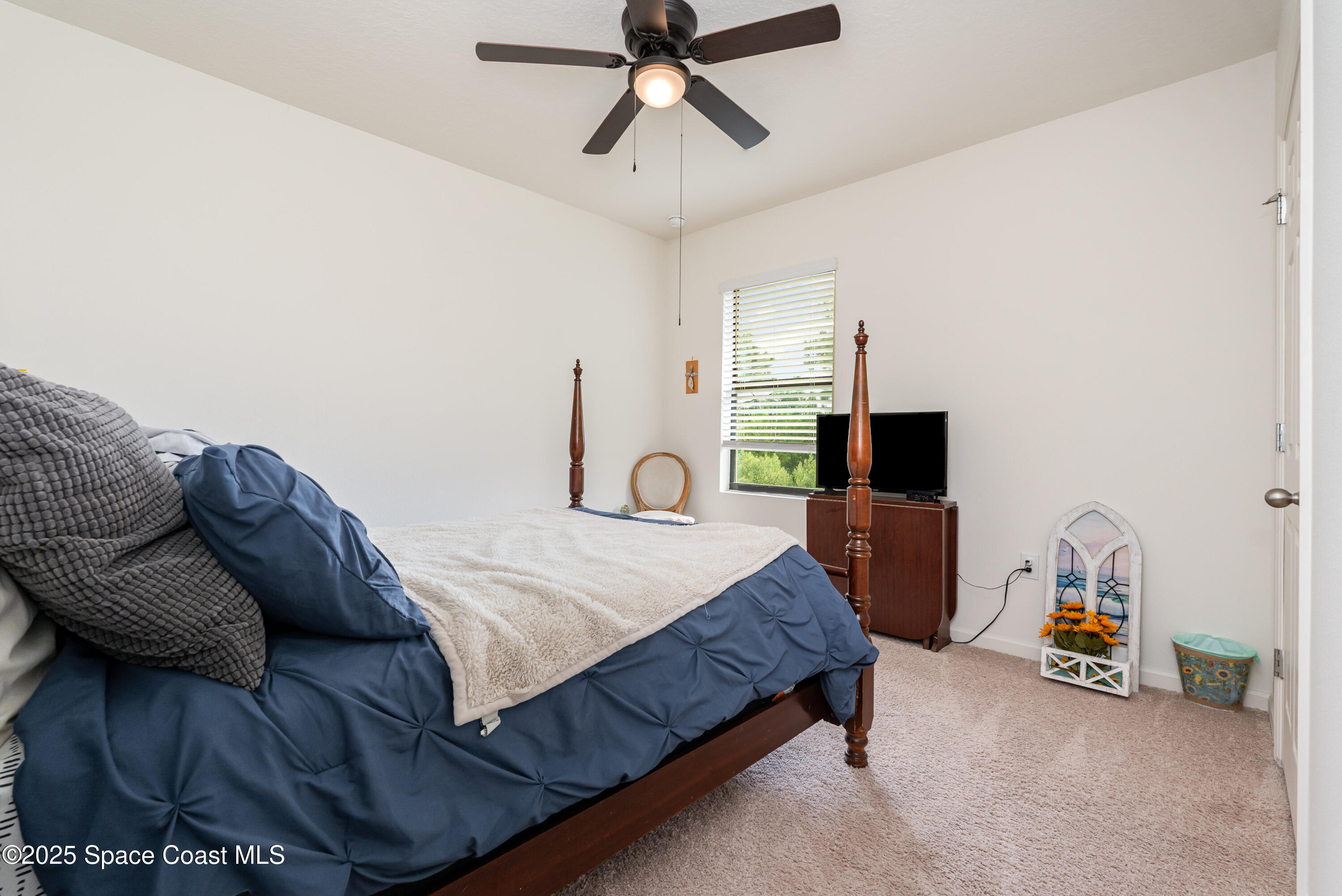 904 Old Country Rd S East Palm Bay, FL 32909 - Photo 20 of 25 a bed room with a bed and a television