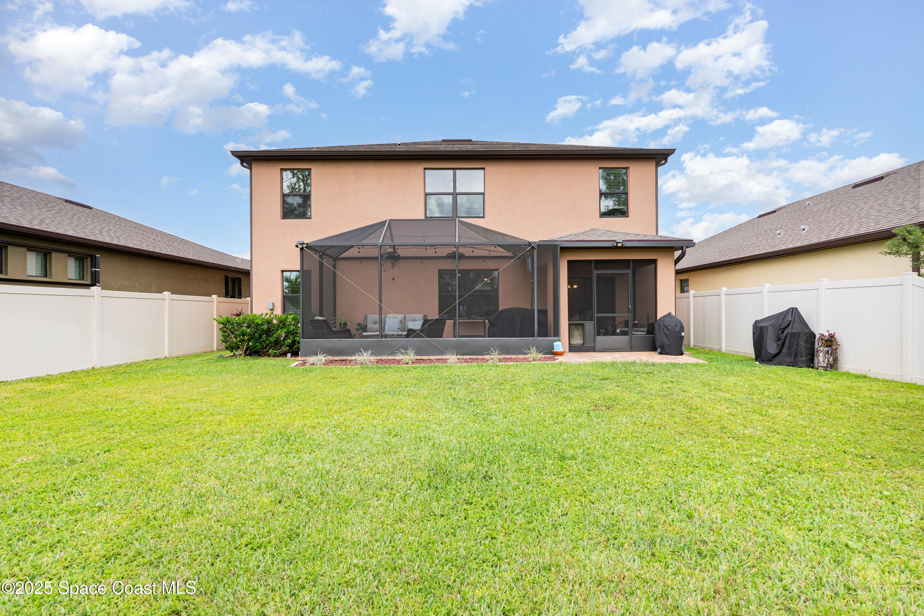 904 Old Country Rd S East Palm Bay, FL 32909 - Photo 2 of 25 a front view of a house with a yard