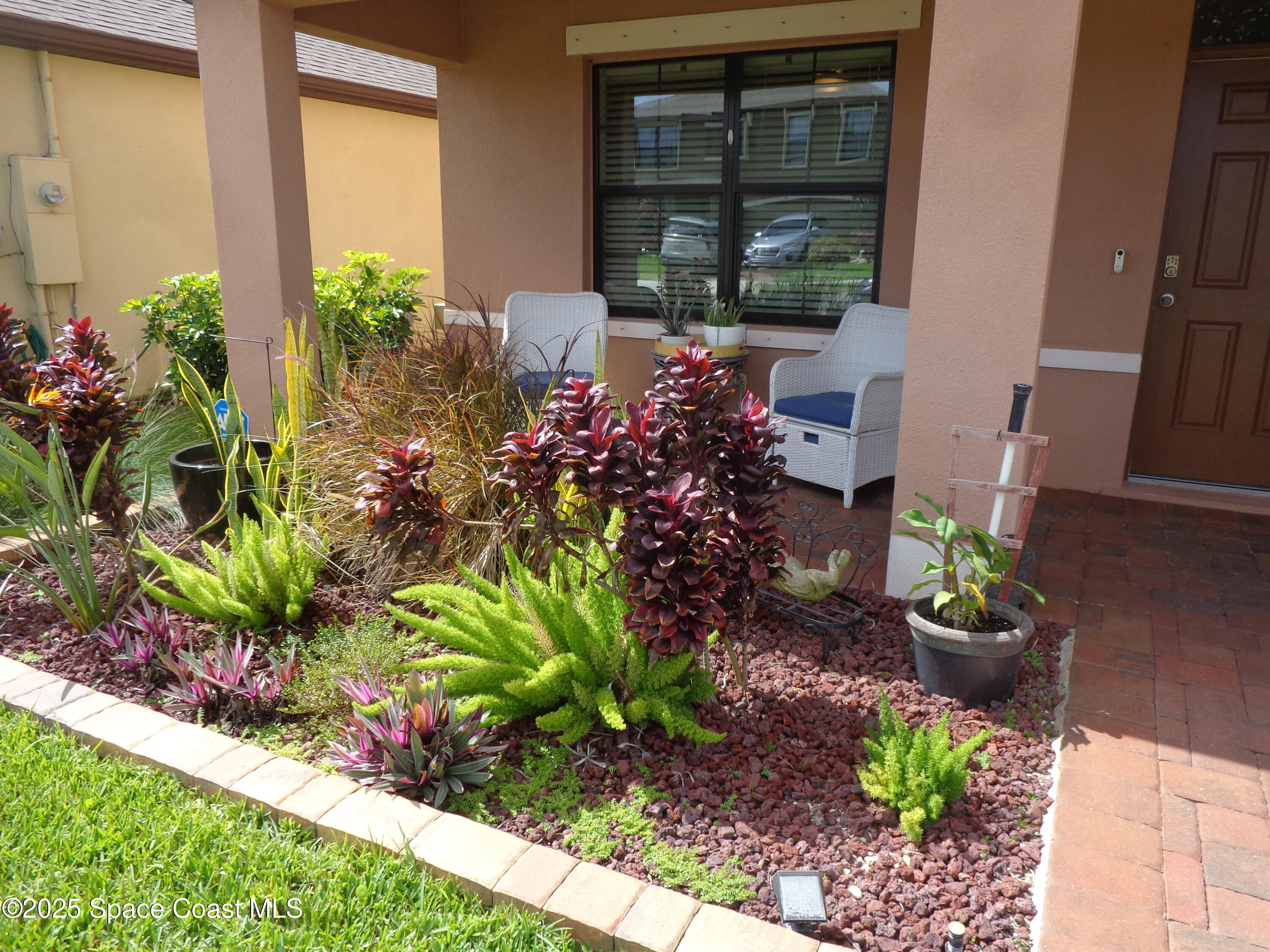 904 Old Country Rd S East Palm Bay, FL 32909 - Photo 25 of 25 a front view of a house with a yard