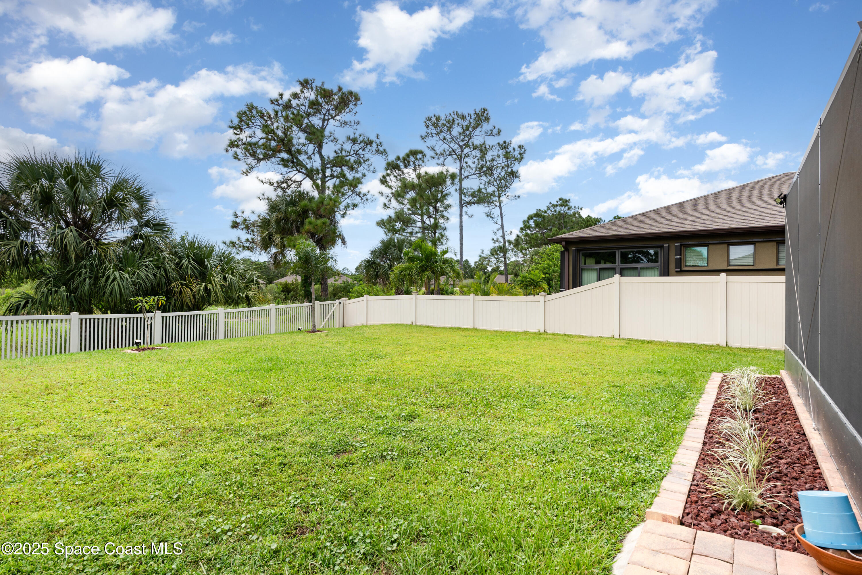 904 Old Country Rd S East Palm Bay, FL 32909 - Photo 3 of 25 a view of a backyard