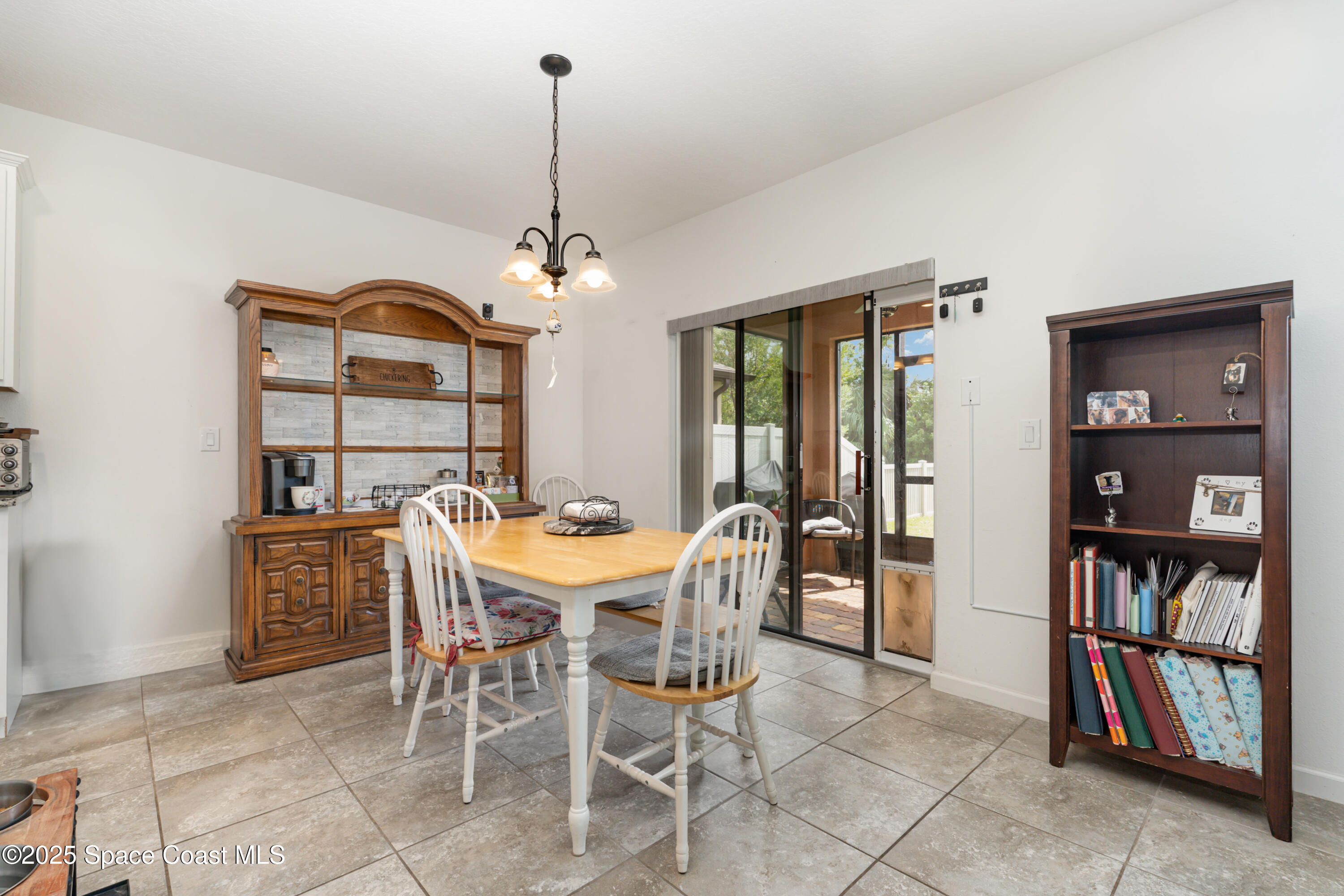 904 Old Country Rd S East Palm Bay, FL 32909 - Photo 8 of 25 a view of a dining room with furniture window and wooden floor