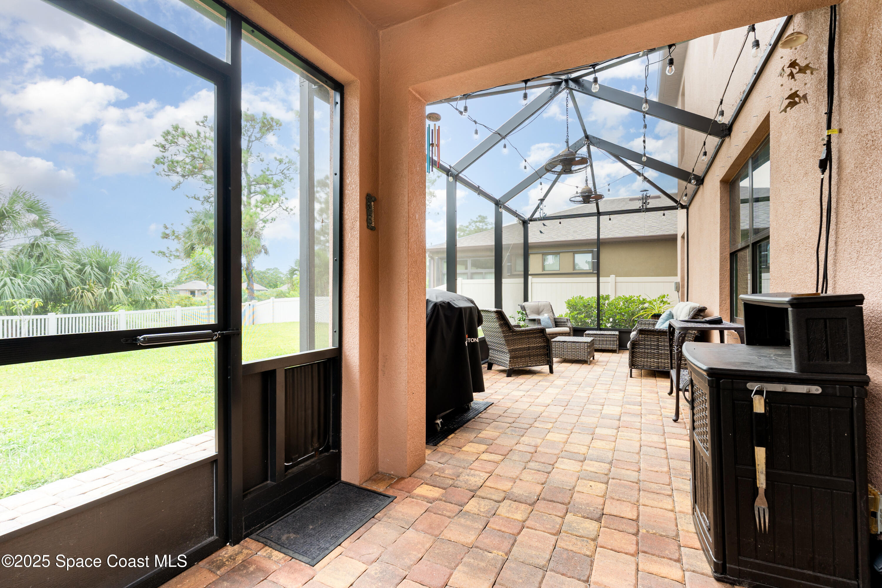 904 Old Country Rd S East Palm Bay, FL 32909 - Photo 10 of 25 a living room with large windows and a table