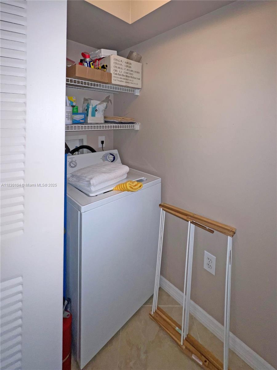 3588 Northwest Adriatic Lane, Unit 202 Jensen Beach, FL 34957 - Photo 13 of 13 a utility room with dryer and washer