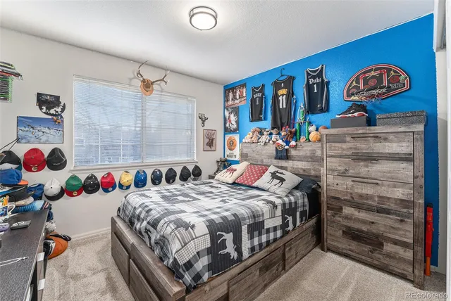 a bed room with a bed and a baby bed