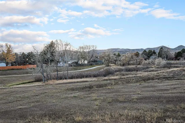 a view of a dry yard with wooden fence