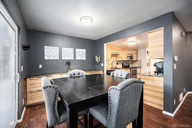 a view of a dining room with furniture and wooden floor