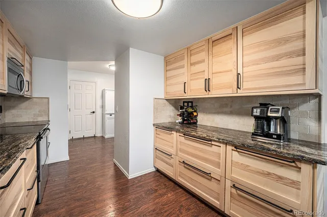 a kitchen with stainless steel appliances granite countertop a stove and a sink