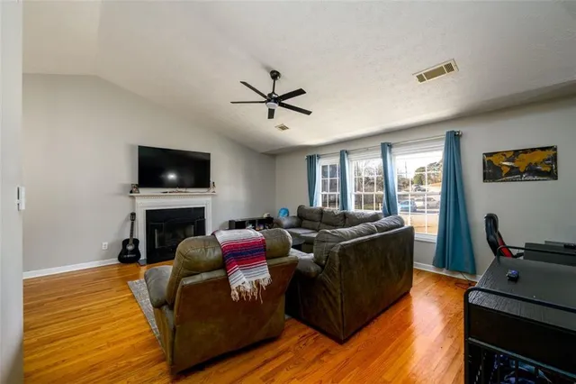 a living room with furniture fireplace and flat screen tv