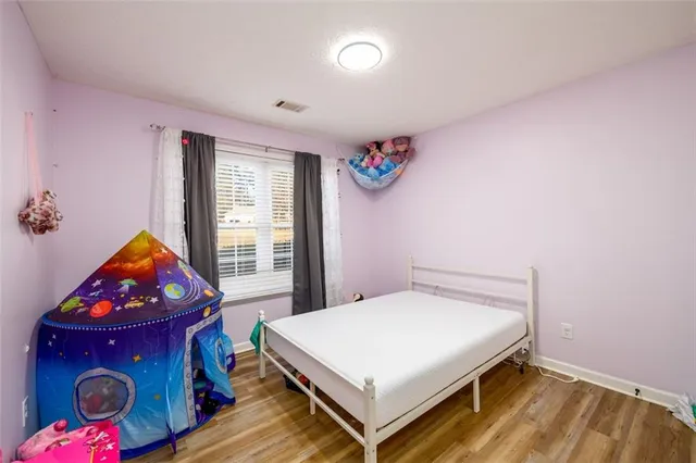 a bedroom with a bed and a window