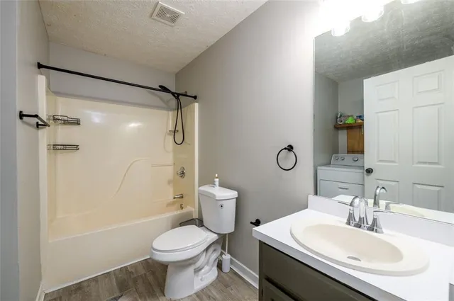 a bathroom with a sink toilet tub and shower