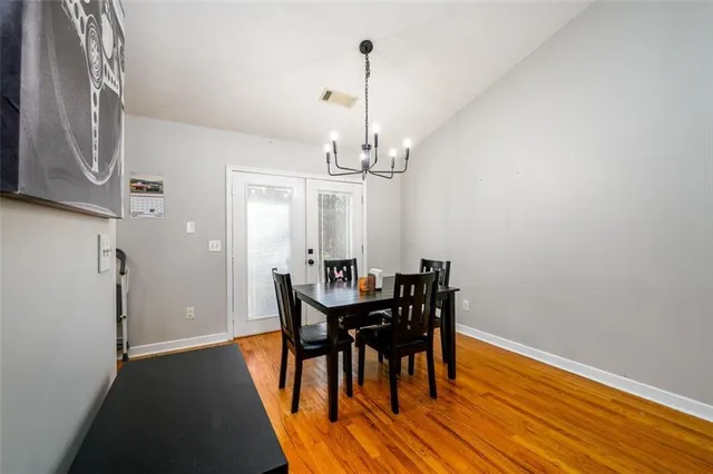 a view of a dining room with furniture and chandelier