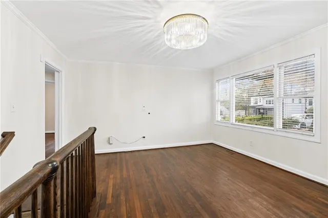 a view of a room with wooden floor and window