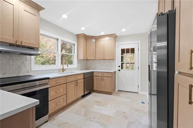 a kitchen with a sink stove and refrigerator
