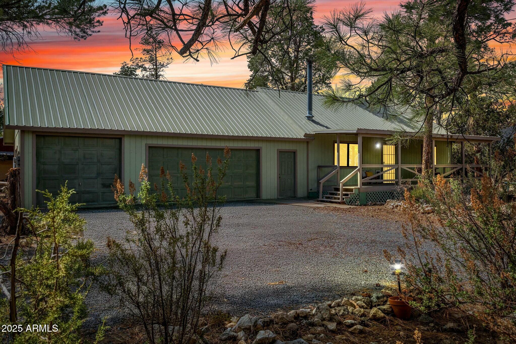 2061 Cherokee Strip Road Overgaard, AZ 85933 - Photo 1 of 40 a front view of a house with garden