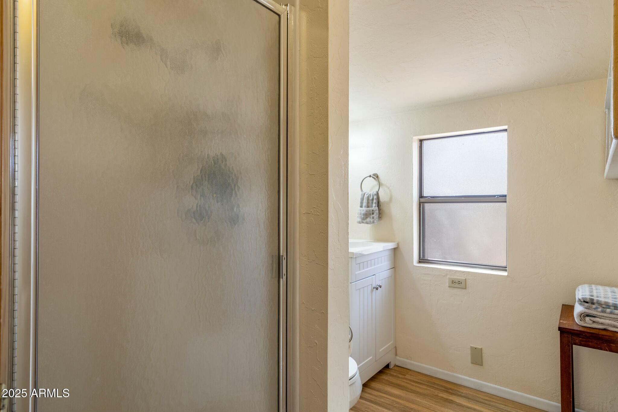 2061 Cherokee Strip Road Overgaard, AZ 85933 - Photo 21 of 40 a bathroom with a glass shower door