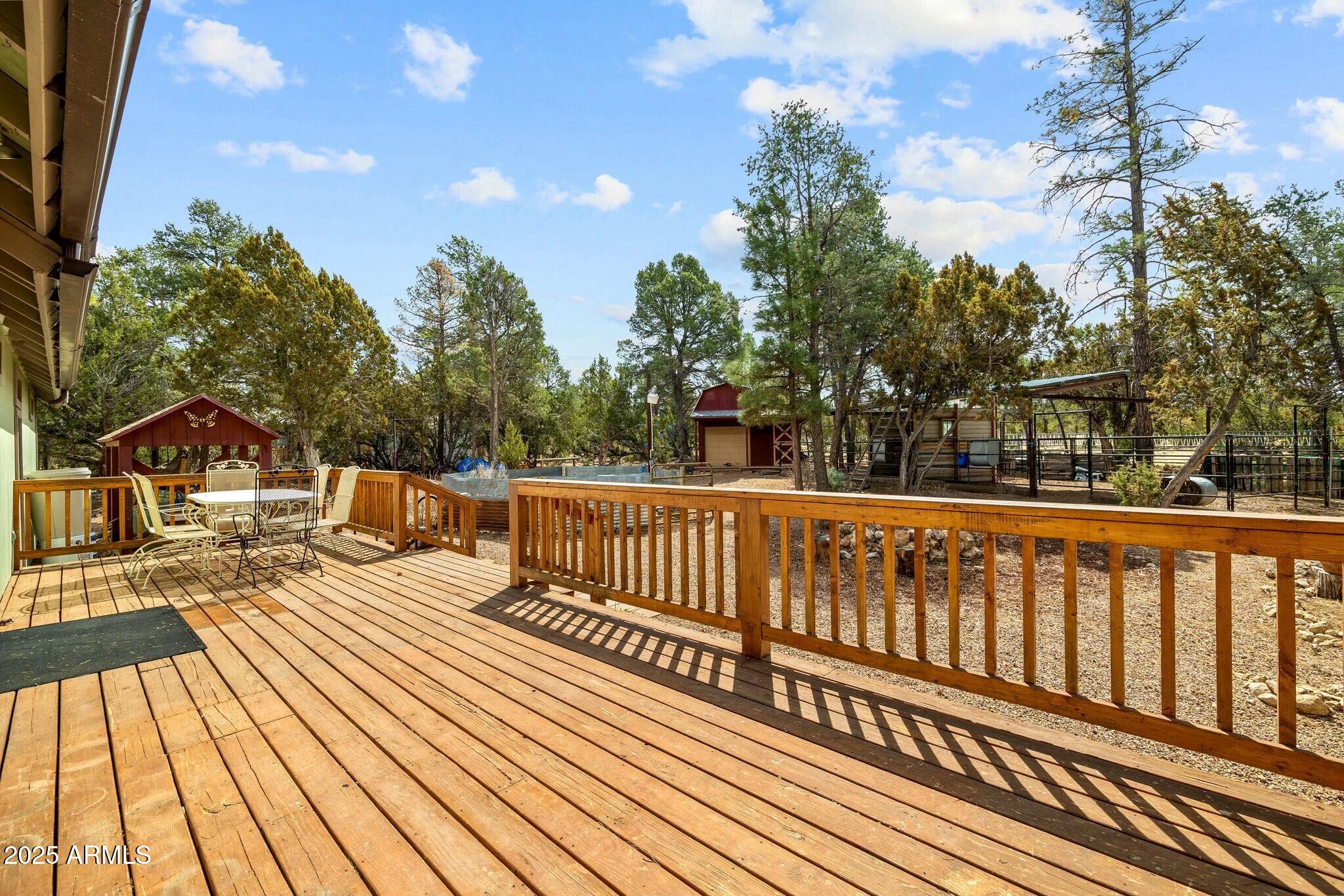 2061 Cherokee Strip Road Overgaard, AZ 85933 - Photo 31 of 40 a view of balcony with wooden floor and iron fence