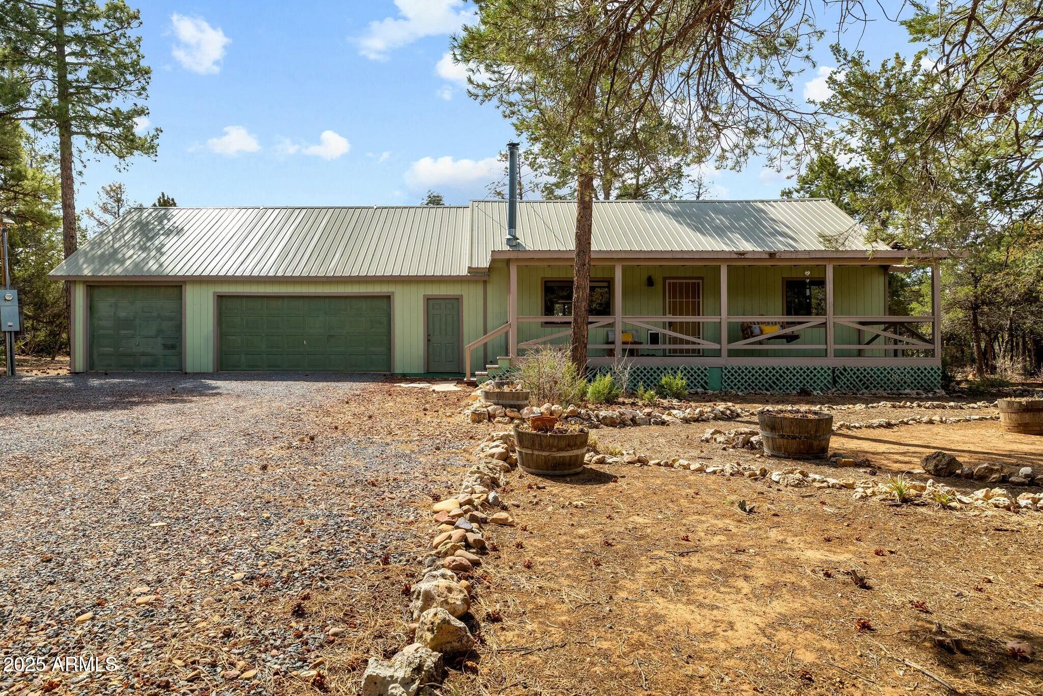2061 Cherokee Strip Road Overgaard, AZ 85933 - Photo 36 of 40 a view of a house with backyard and sitting area
