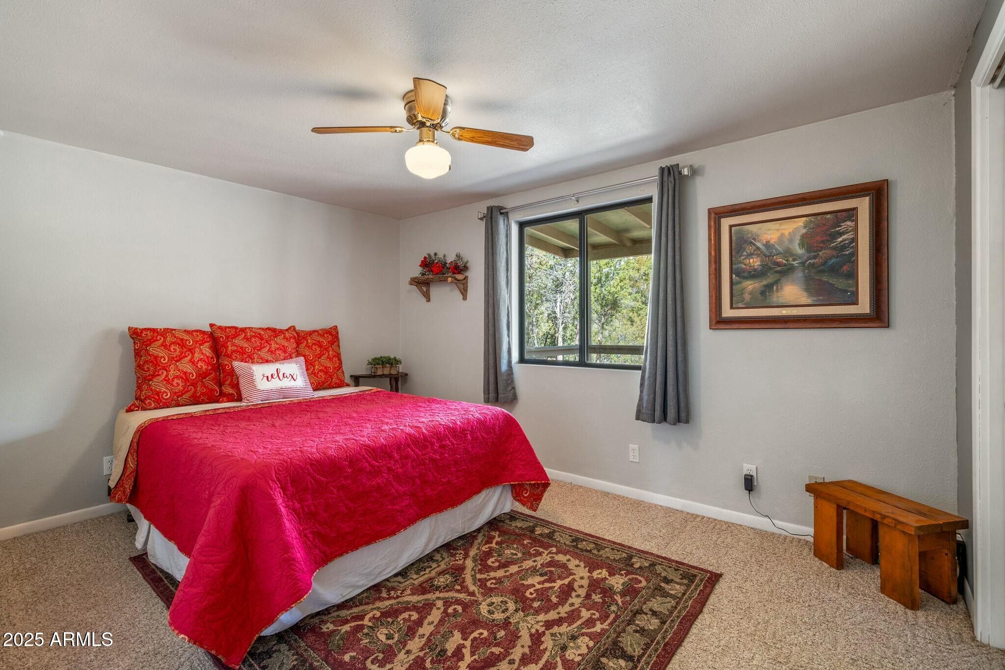 2061 Cherokee Strip Road Overgaard, AZ 85933 - Photo 5 of 40 a bedroom with a bed and a window