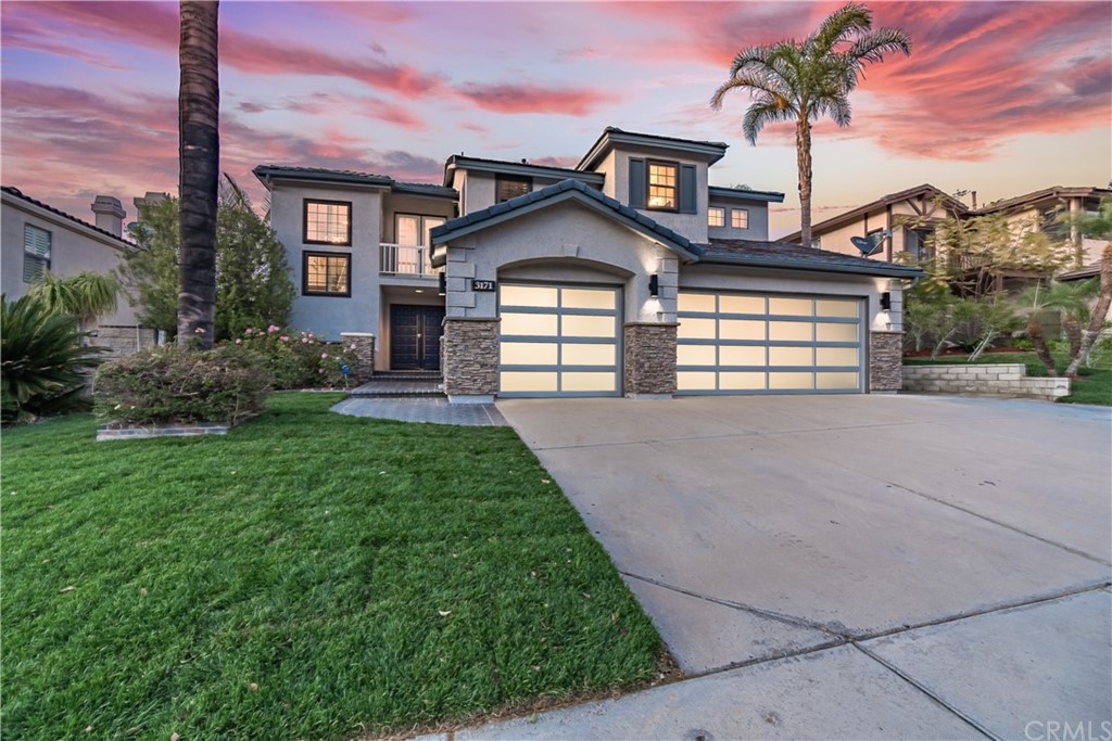 a front view of a house with a yard and garage
