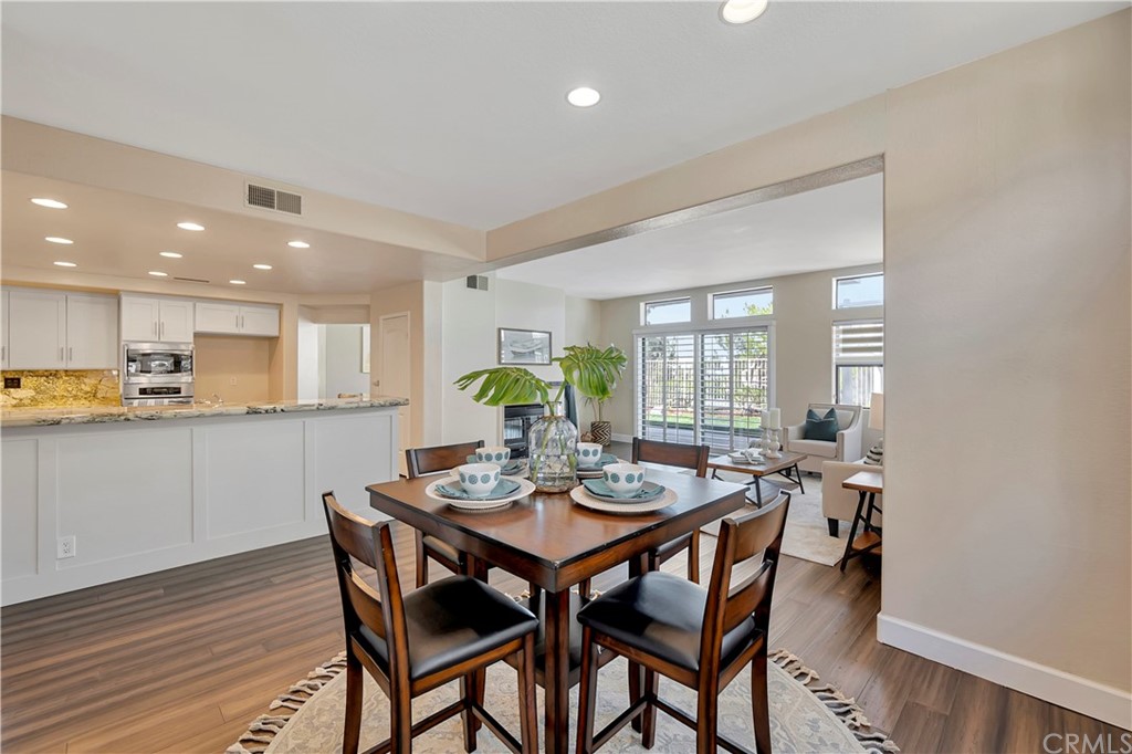 3171 Diamond View Street Corona, CA 92882 - Photo 15 of 59 a view of a dining room and livingroom with furniture wooden floor and a rug