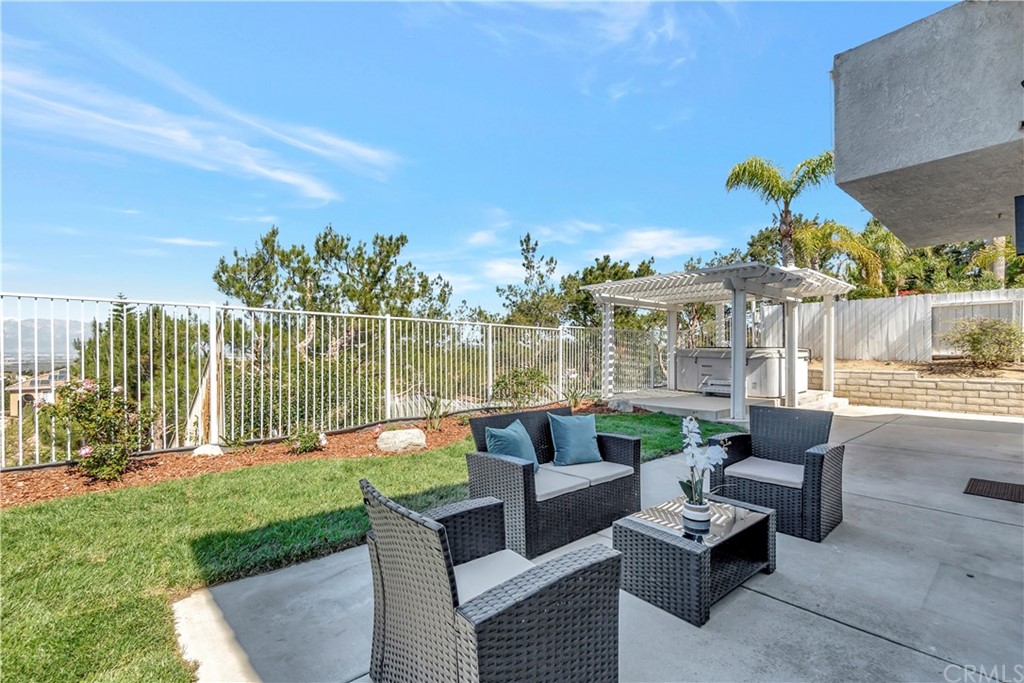 3171 Diamond View Street Corona, CA 92882 - Photo 21 of 59 a view of a patio with couches potted plants and a palm tree