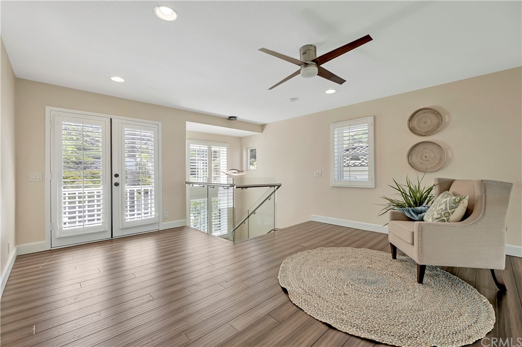 3171 Diamond View Street Corona, CA 92882 - Photo 38 of 59 a living room with couches chairs and kitchen view with wooden floor