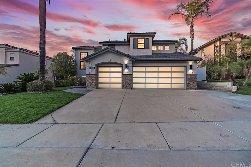3171 Diamond View Street Corona, CA 92882 - Photo 46 of 59 a front view of a house with a yard and garage