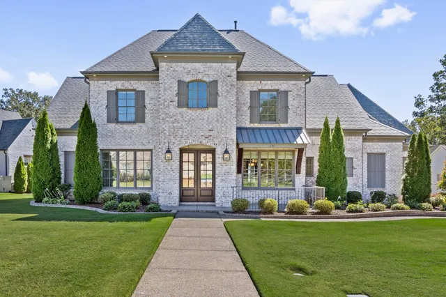 a front view of a house with garden