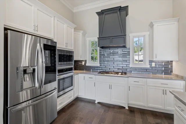 a kitchen with stainless steel appliances a refrigerator sink and cabinets