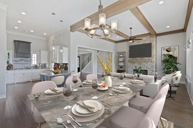 a dining room with furniture a fireplace and chandelier