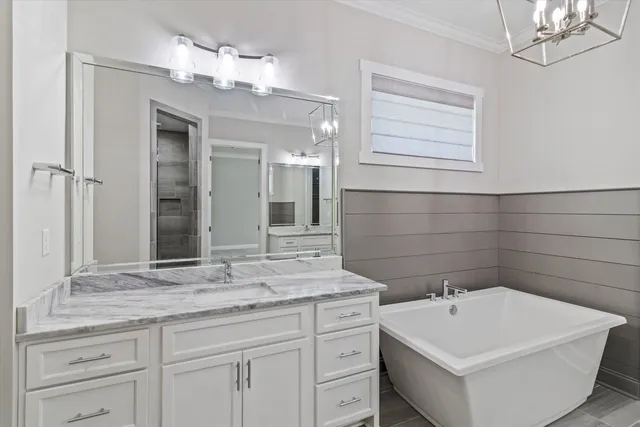 a bathroom with a sink a large mirror and a bathtub