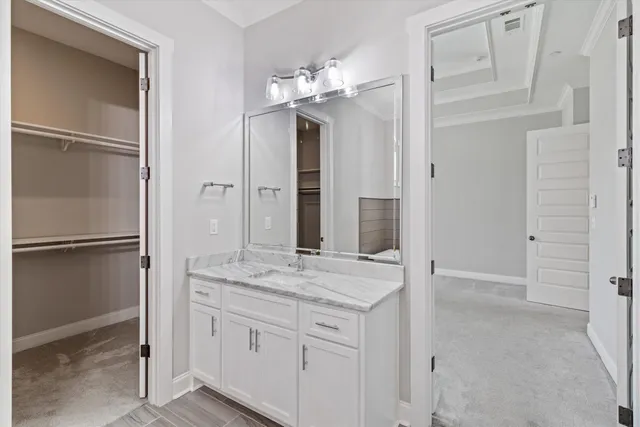 a bathroom with a granite countertop shower a mirror and a sink