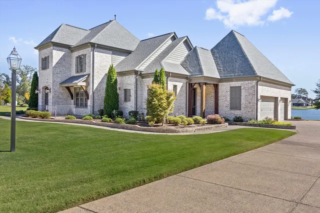 a front view of house with yard and green space