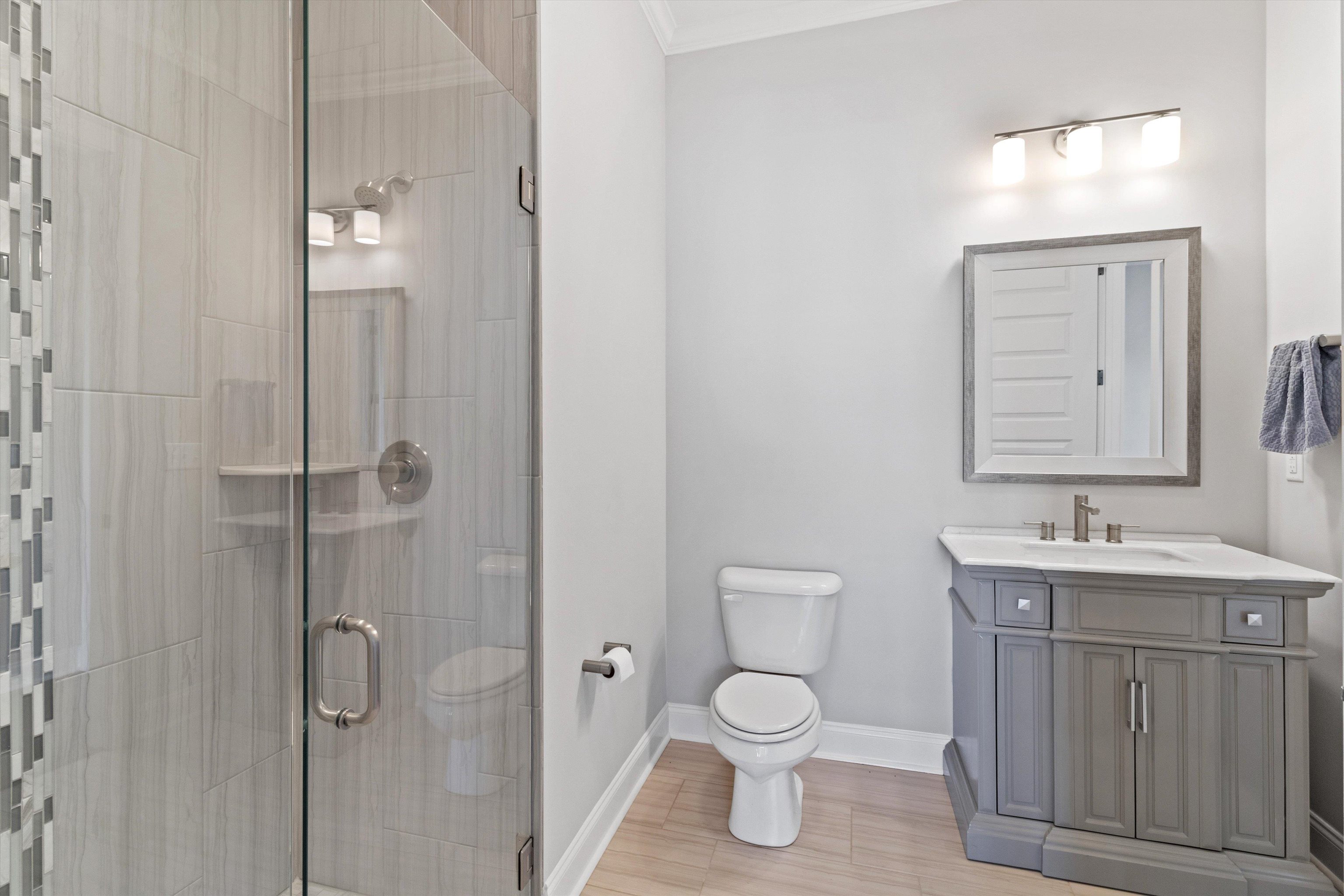 680 Magnolia Lane Piperton, TN 38017 - Photo 24 of 40 a bathroom with a toilet a sink and mirror