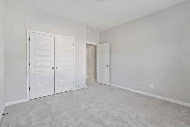 a view of an empty room and closet area