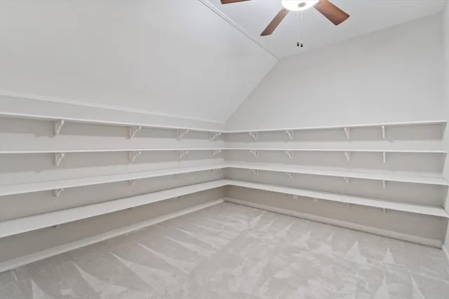 a view of walk in closet with empty racks
