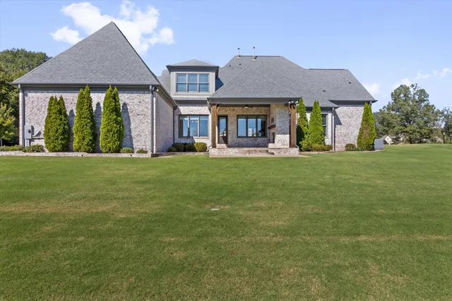 a front view of a house with a yard