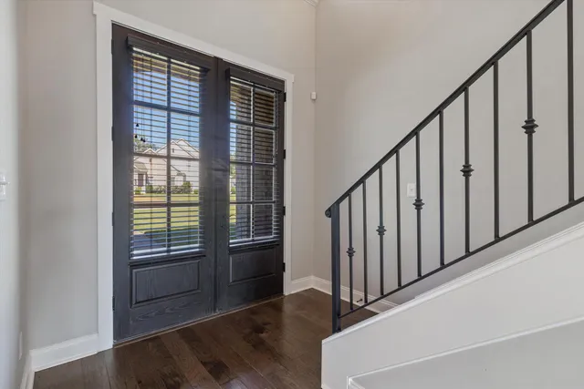a view of an entryway with wooden floor
