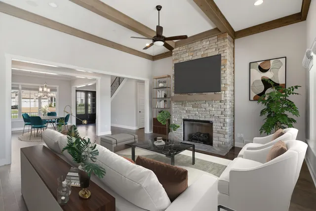 a living room with furniture a flat screen tv and a fireplace