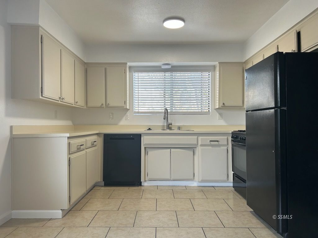 824 C Capehart Court Ridgecrest, CA 93555 - Photo 3 of 11 a kitchen with a sink stove and refrigerator