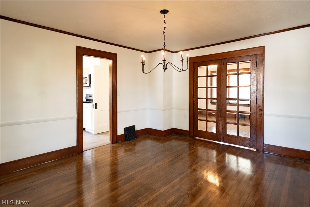 1022 North Howard Street Akron, OH 44310 - Photo 7 of 38 Dining room with a chandelier, dark hardwood and French doors leading to living room.