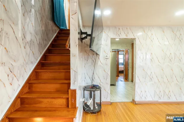 a view of entryway and hall with wooden floor