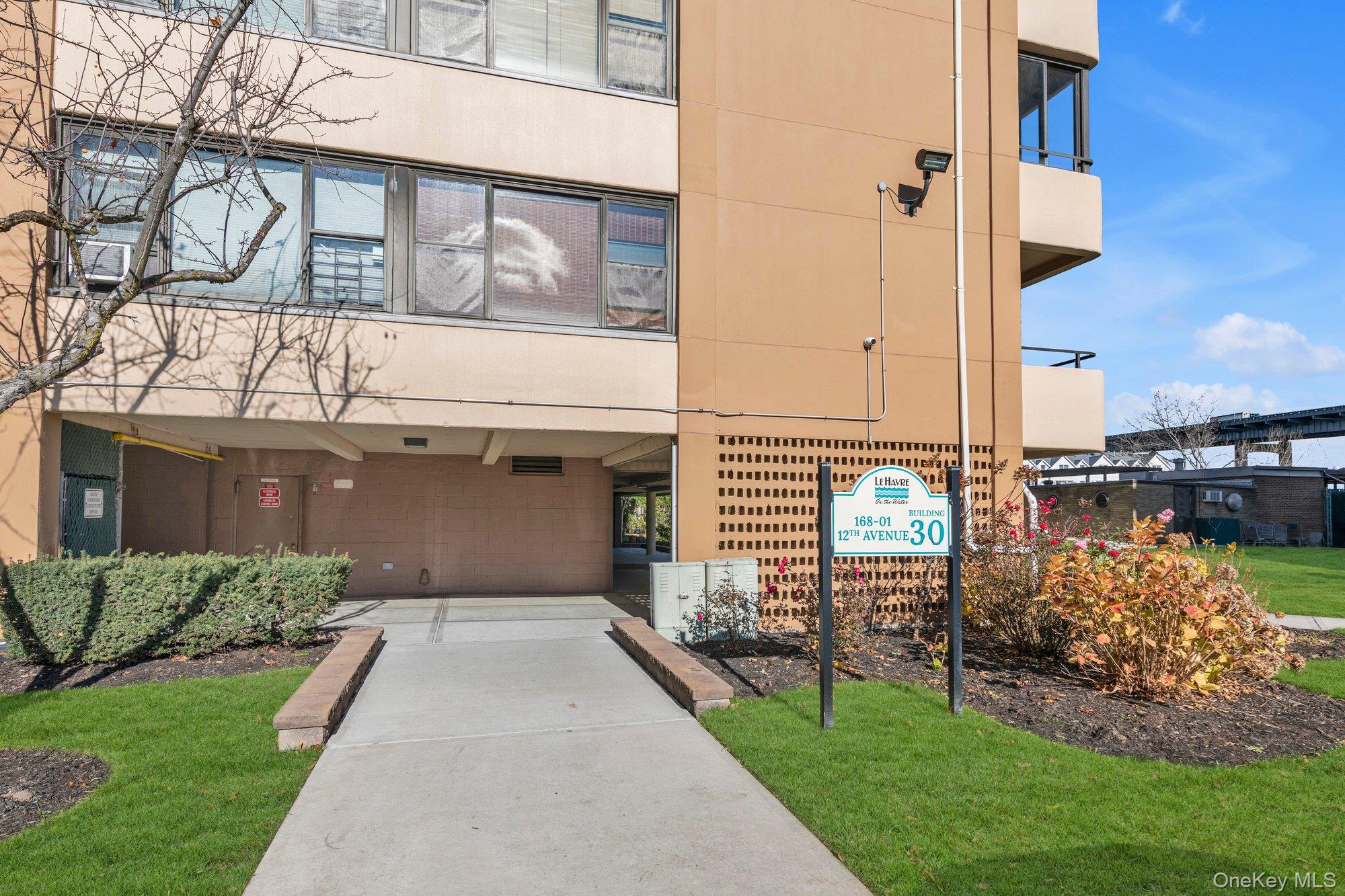 168-01 12th Avenue, Unit 7B Queens, NY 11357 - Photo 10 of 12 a front view of a house with a yard