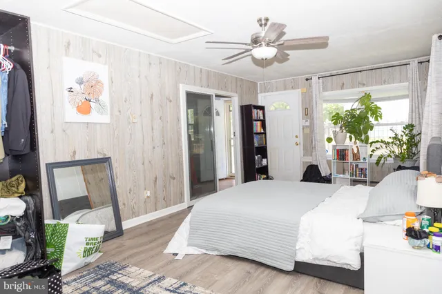 a bedroom with a large bed and a chandelier