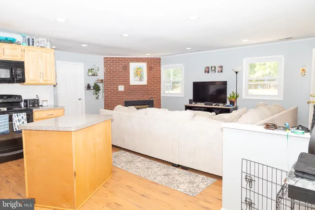 a living room with washer and a flat screen tv