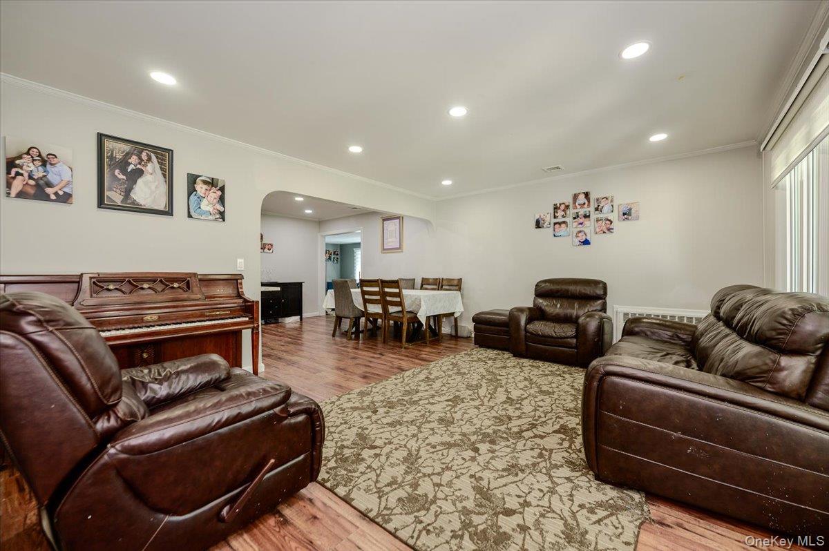 534 Allen Road Woodmere, NY 11598 - Photo 5 of 35 a living room with furniture a flat screen tv and a piano